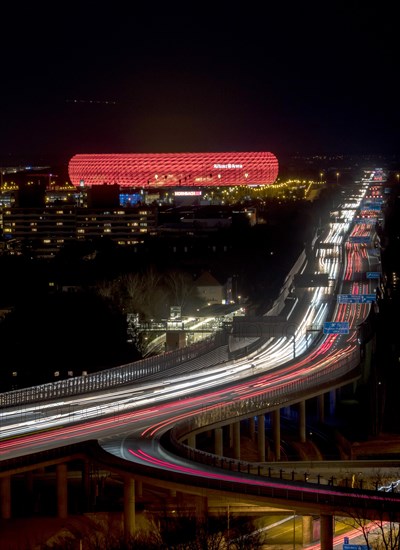 Red lit Allianz Arena at A9 motorway