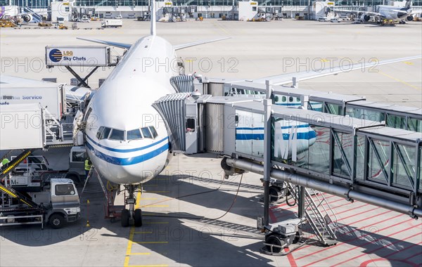 Passenger aircraft with docked passenger boarding bridge