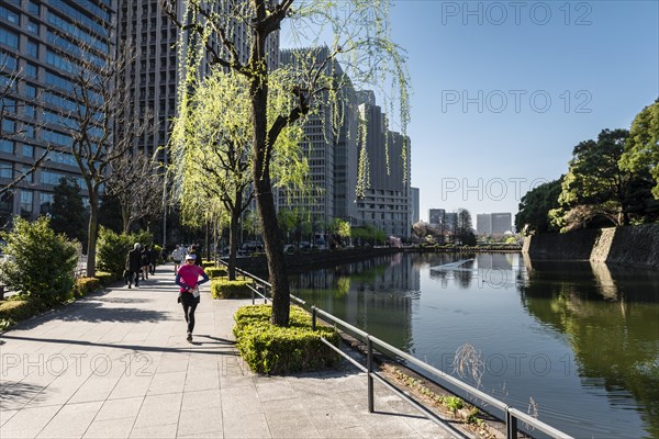 Promenade with pedestrians at the castle moat