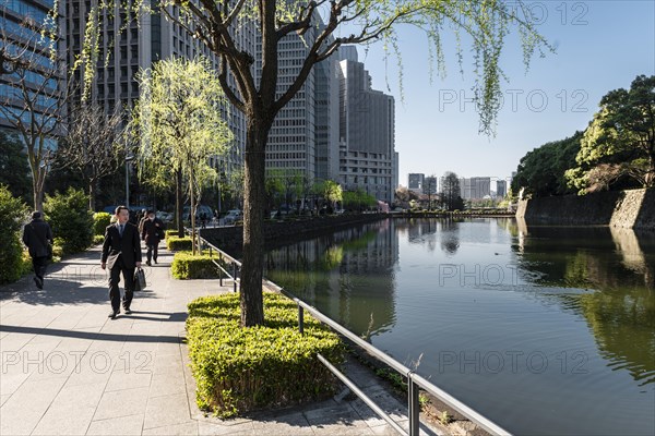 Promenade with pedestrians at the castle moat