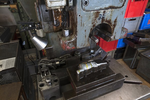 Squeezing machine from the 1950s with mold and ready pressed elephants