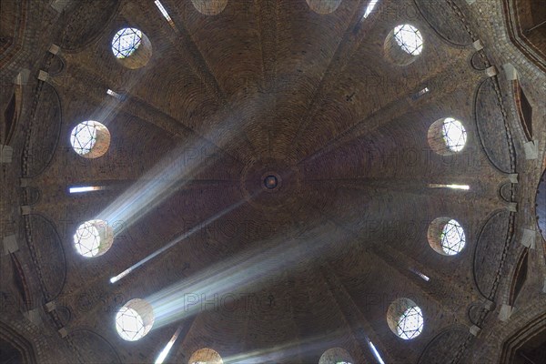 Rays of light shine through windows of the dome