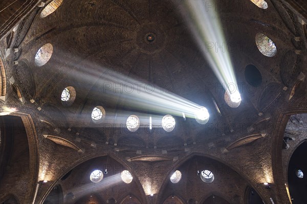 Rays of light shine through windows of the dome