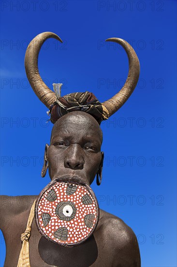 Woman with large lip plate and horns