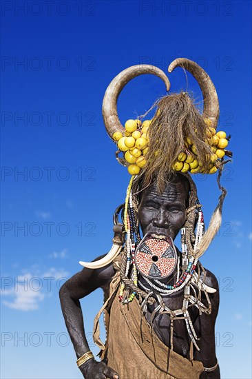 Woman with large lip plate and horns