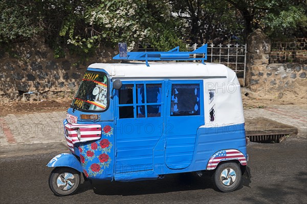 Tuk-Tuk driving on the road