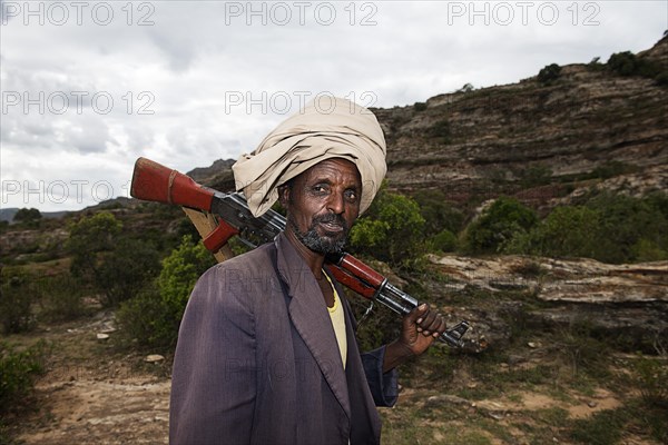 Local guide with Kalashnikov