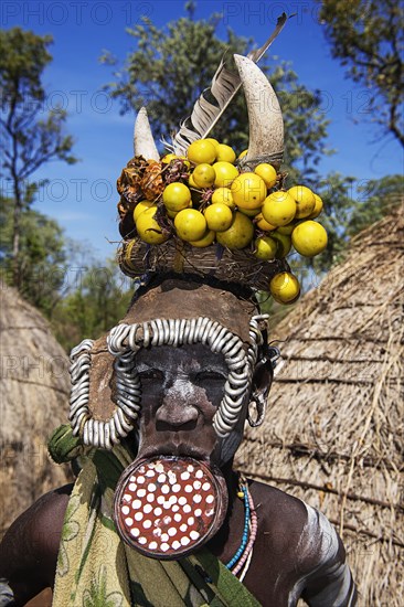 Woman with large lip plate and headdress