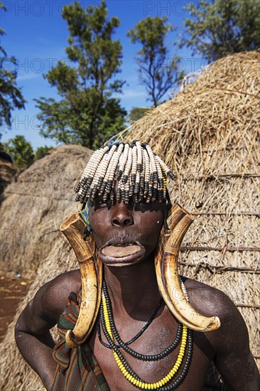 Woman with lip plate and headdress