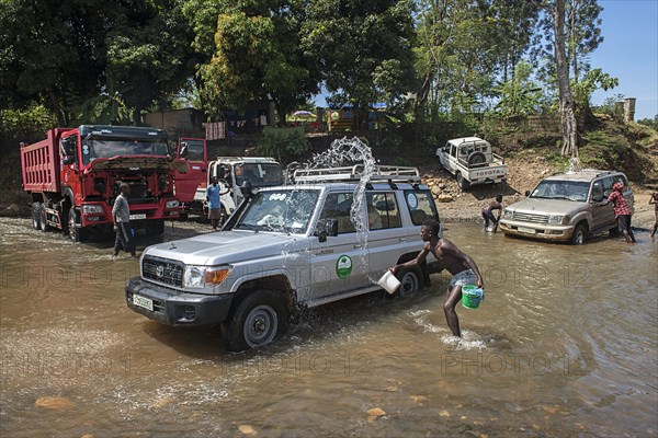 Cars are washed in the river