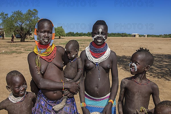 Women of the tribe of the Karo with face painting and necklace