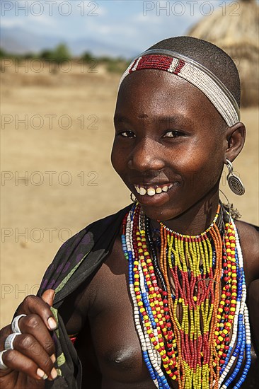 Laughing young woman with necklace