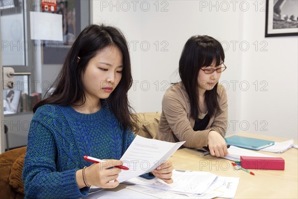 Foreign women in German lessons in an international class