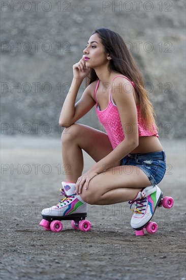 Young woman poses with roller skates