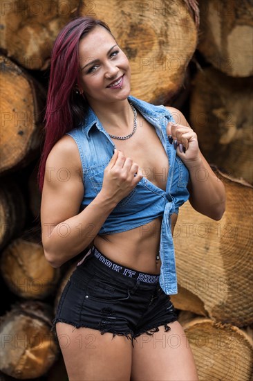 Young woman with jeans jacket and black hotpants