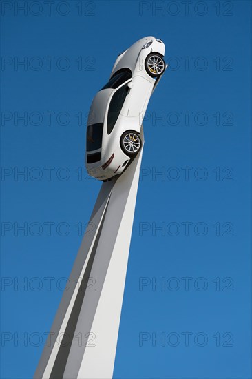 Porsche 911 Carrera 2015 on a white pedestal