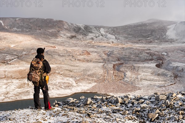 Tourist guide with rifle on the lookout for polar bears