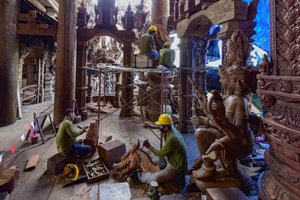 Craftsman carving wooden figures in the Sanctuary of Truth Temple