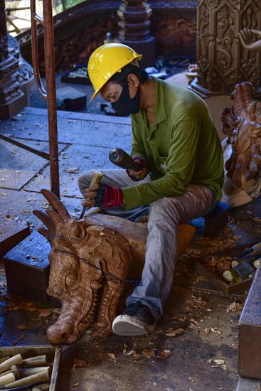 Craftsman carving a dragon figure in the Sanctuary of Truth Temple