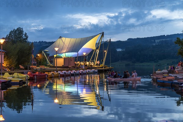 Beach concert at dusk with the band Buhl on the lake stage