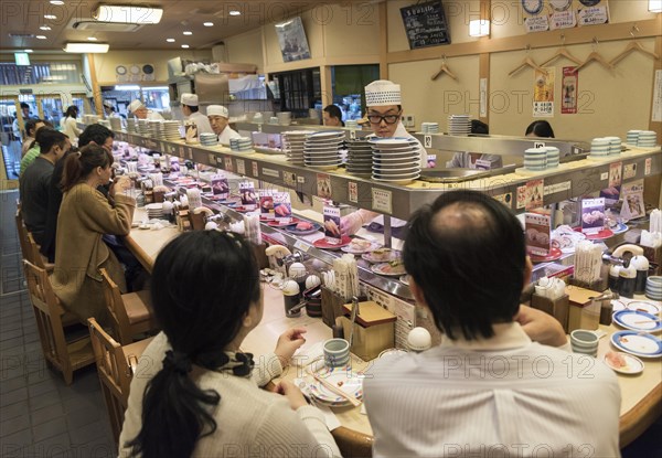 Kaiten-zushi restaurant serving sushi on rotating conveyor belt