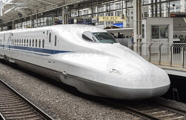 Shinkansen bullet train arriving to railway station