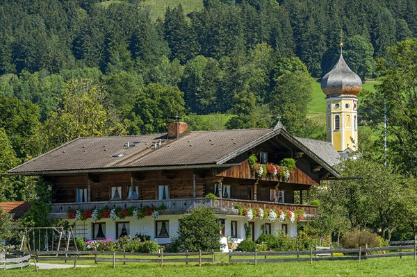 Old farmhouse with flowers and former monastery St. Martin