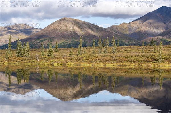 Autumnal tundral landscape reflected in lake