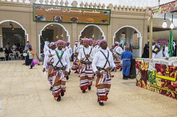 Traditional dressed local men dancing at the Al Janadriyah Festival