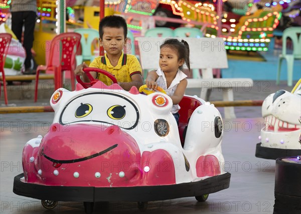 Children driving bumper cars in Koh Pich theme park