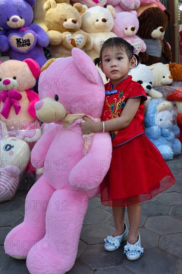 Little girl with big teddy bear in Koh Pich theme park