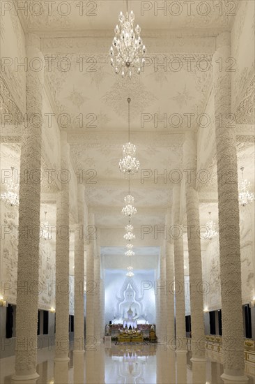 Ornamental columns in the white prayer hall with Buddha statue