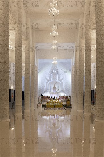 Ornamental columns in the white prayer hall with Buddha statue