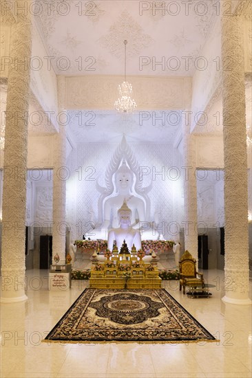 Ornamental columns in the white prayer hall with Buddha statue