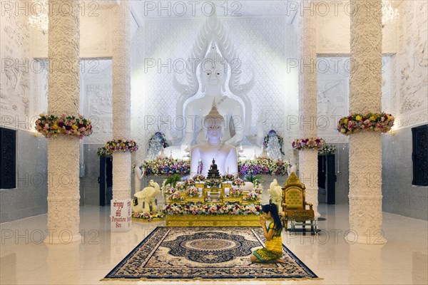 Ornamental columns in the white prayer hall with Buddha statue