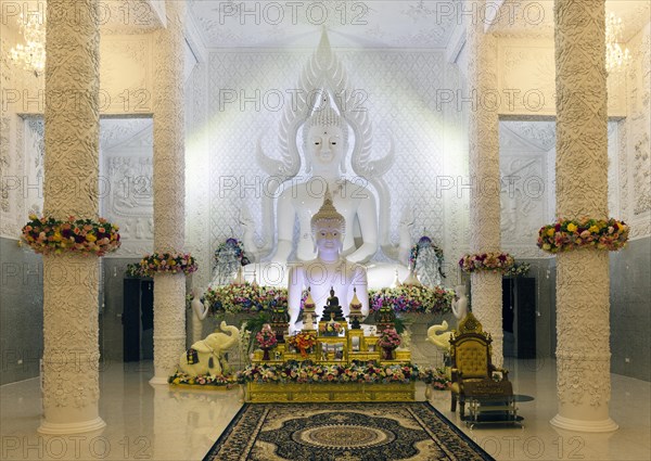 Ornamental columns in the white prayer hall with Buddha statue