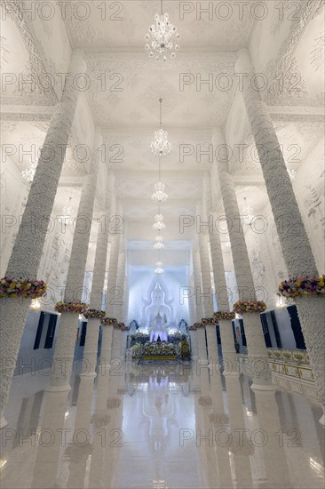 Ornamental columns in the white prayer hall with Buddha statue