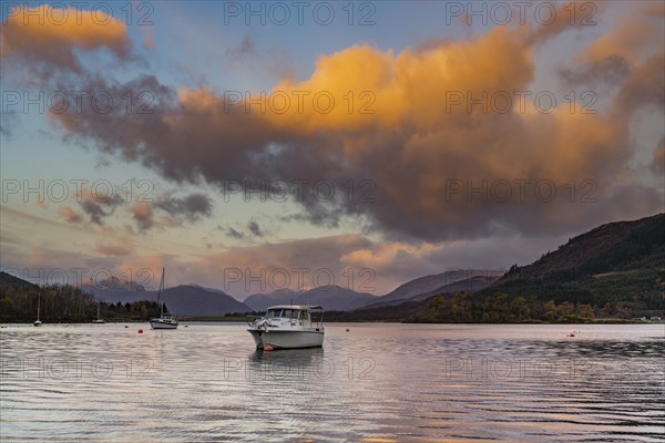 Boats with Loch Linnhe at sunrise with coloured clouds