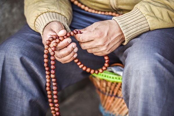 Hands with Buddhist prayer chain