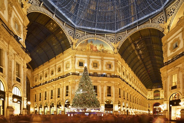 People marvel at Christmas tree and Christmas lights in luxury shopping arcade