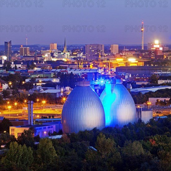 City viwe with the illuminated digesters of WWTP Dortmund Deusen II