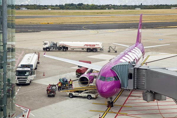 Airplane at the passenger boarding bridge on the runway