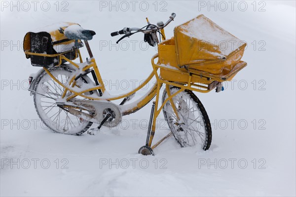 Yellow post bike in the snow