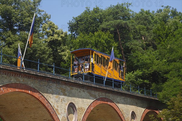 Waggon of Nerobergbahn drives over arch bridge