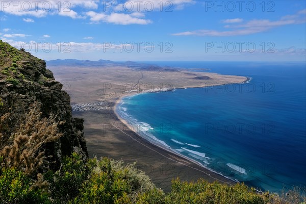 View from Mirador del Bosquecillo to Caleta de Famara with beach Playa de Famara