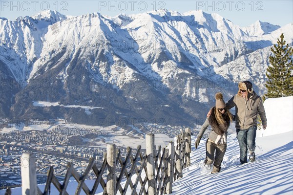 Woman and man walking in mountain scenery