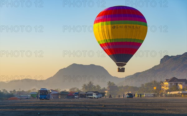 Colorful hot air balloon in the air before landing