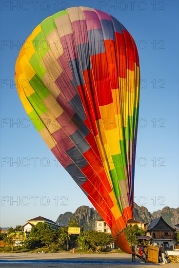 Colourful hot air balloon on ground after landing