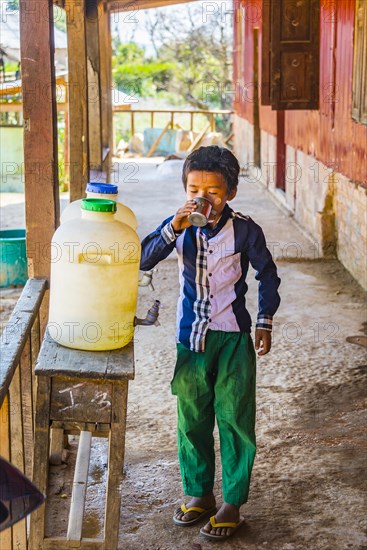 Young boy drinking water