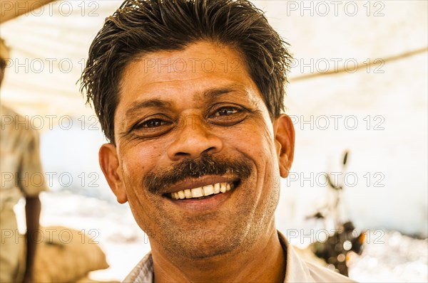 Laughing shopkeeper in a market